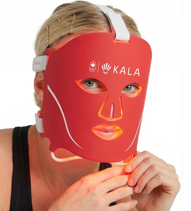 Kala Red Light Person receiving red light therapy on their face with a device held close to their skin.