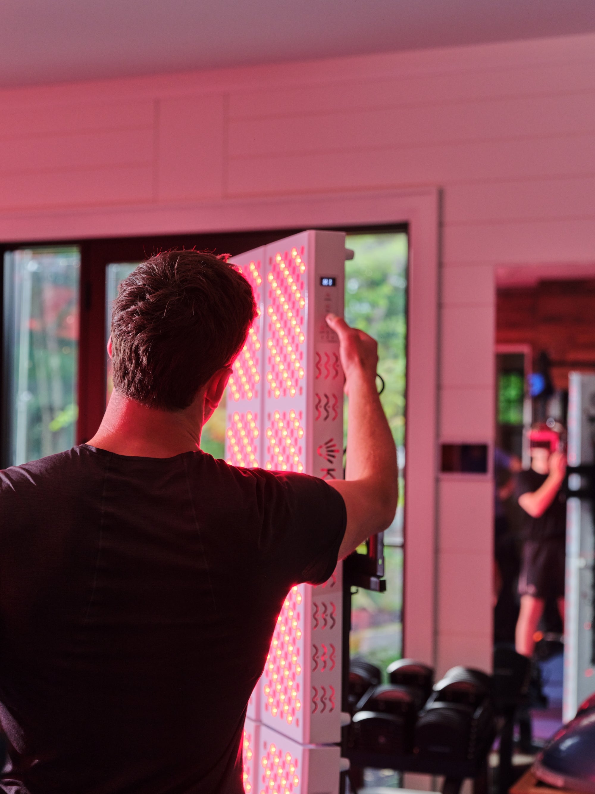 Person interacting with a large Kala LED panel in an indoor setting. Full-body power. Maximum performance.
