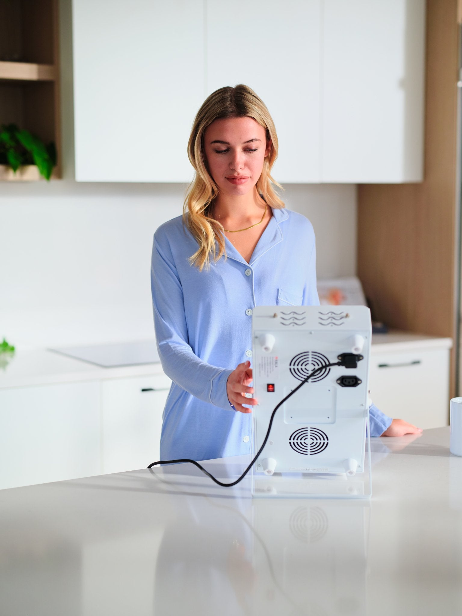 Woman holding a clear Kala Red Light Pro Panel delivers professional-grade red and near-infrared therapy for half-body coverage.