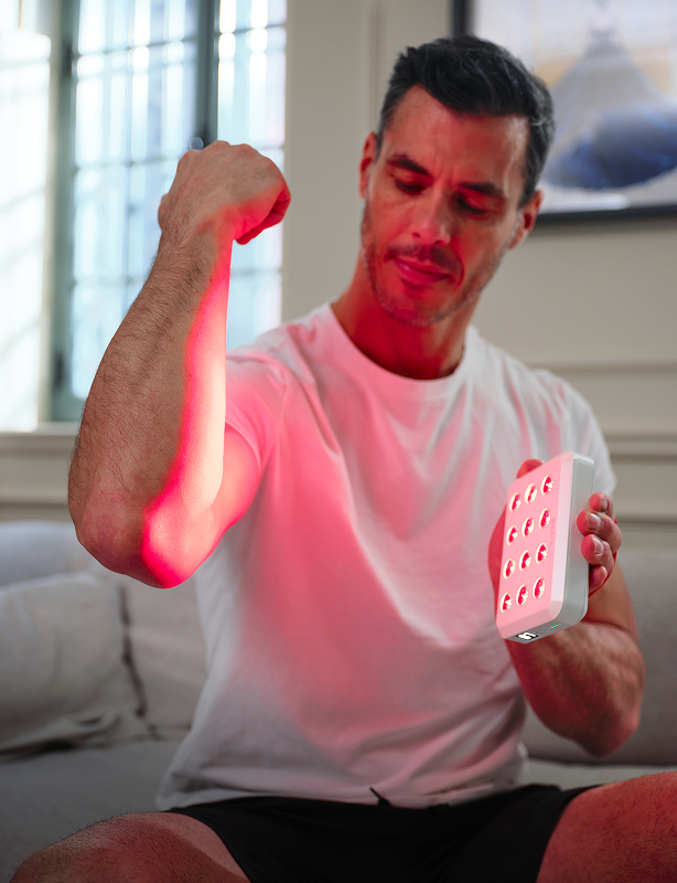 Man using a kala red light therapy device.