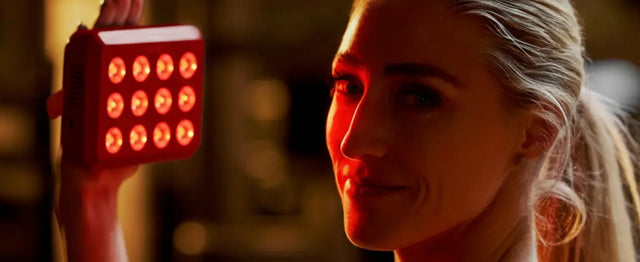 Kala Red Light Woman holding a red light device